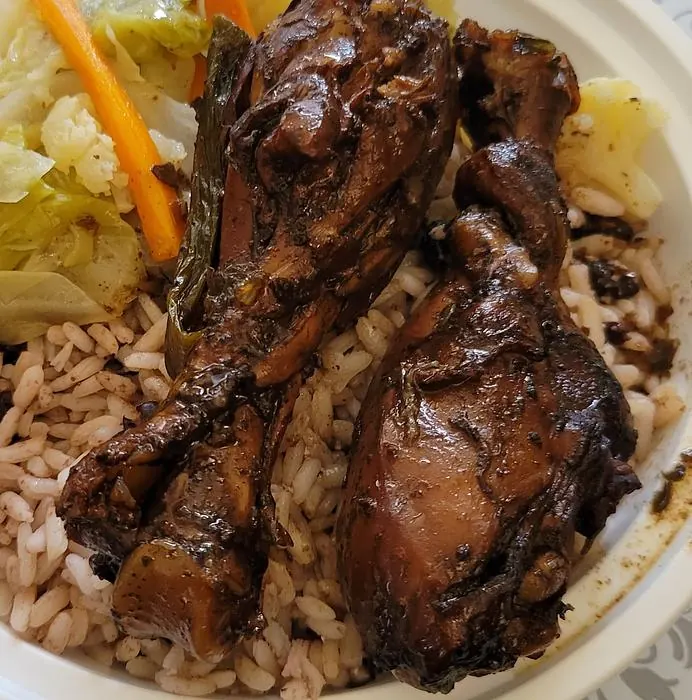 Brown stew chicken plate with plantains and vegetables