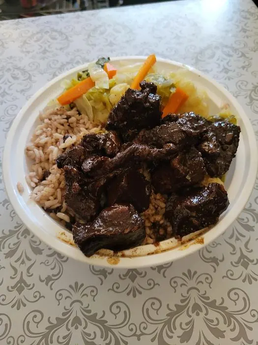 Oxtail served with rice and steamed vegetables